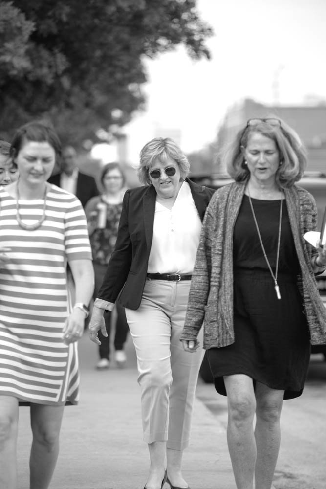 Smith chats with Economic Development Director Sarah Kerner, left, and Deputy City Attorney Jan Millington, right, as the trio walk to a meeting.